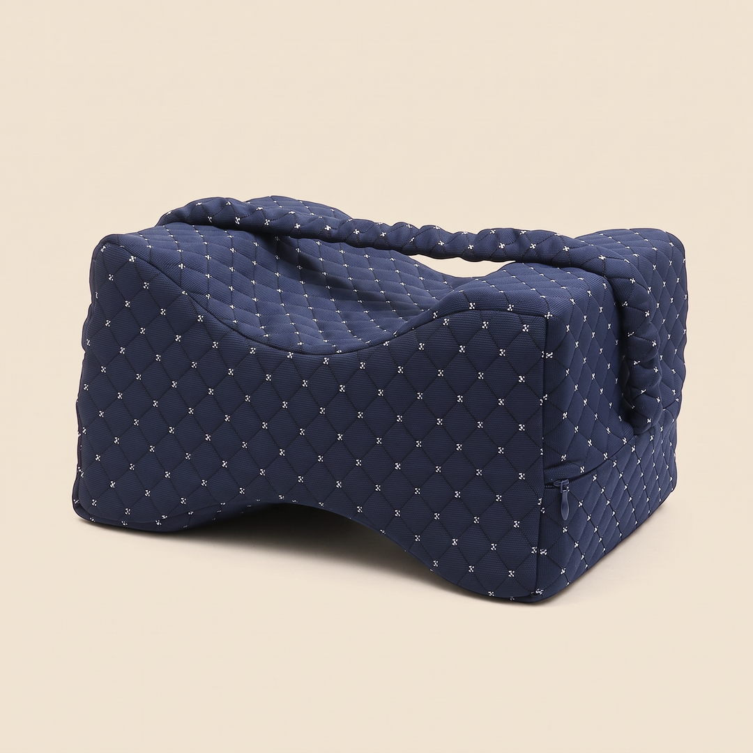 Memory Foam Knee Pillow with Strap in Navy Blue – angled three-quarter view on a plain beige background