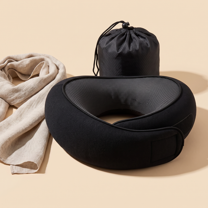 Memory Foam Neck Pillow for Travel in Black – styled with a crumpled linen scarf and pouch behind