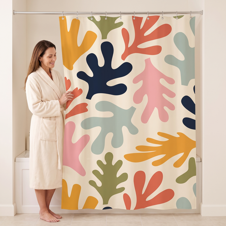 Mid-Century Modern Shower Curtain – Abstract Art in Cream Leaf Cut-Outs – woman in a bathrobe standing beside it, holding the edge