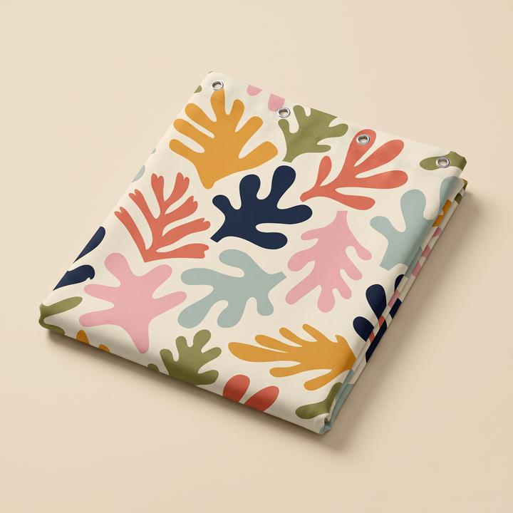 Mid-Century Modern Shower Curtain – Abstract Art in Cream Leaf Cut-Outs – folded flat on a plain beige background showing grommets