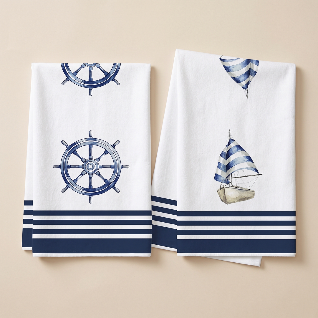 Nautical Kitchen Towels – Set of 2 in Navy Ship Wheel &amp; Sailboat – two folded towels laid flat side by side on beige