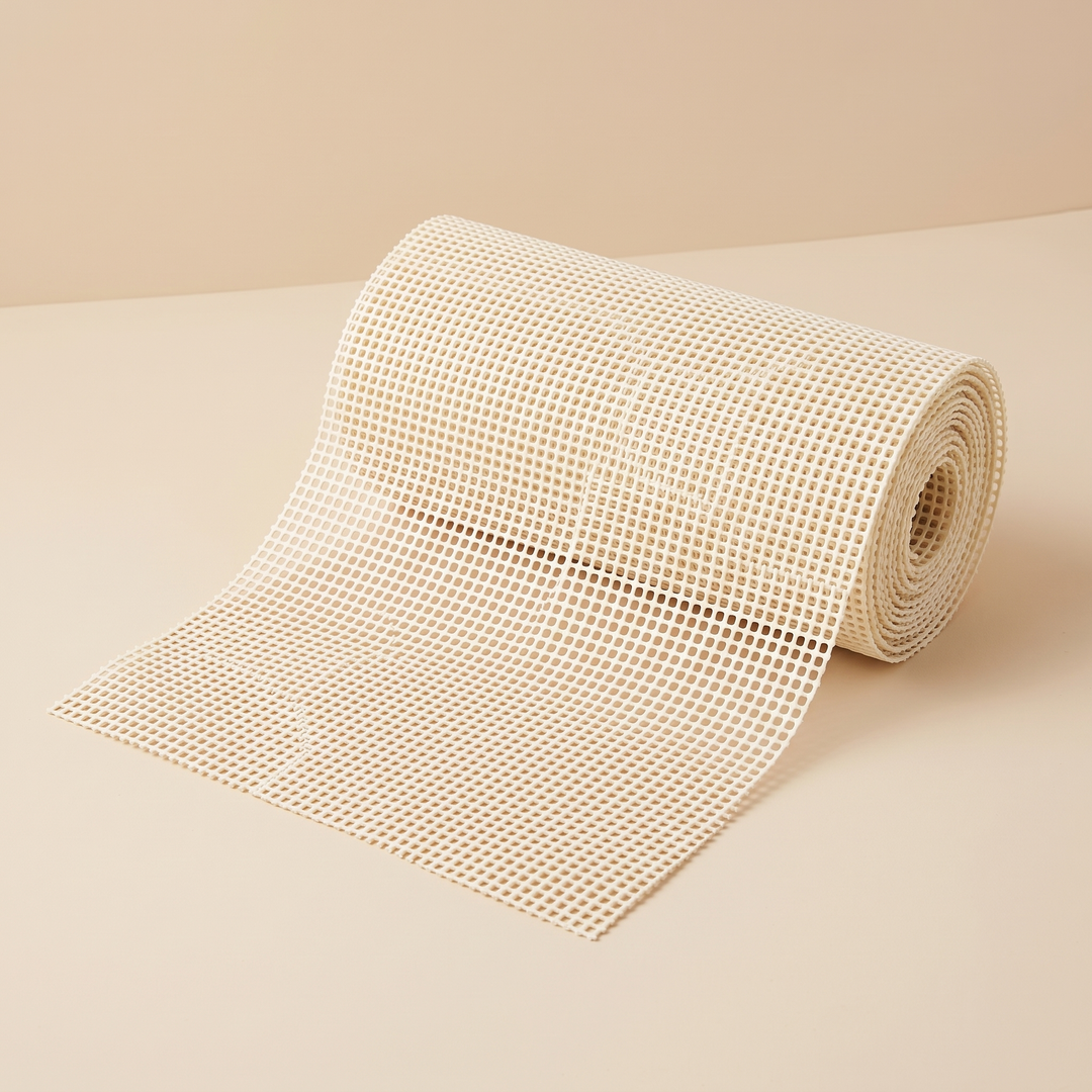 Non-Slip Rug Pad – Cut to Size in Cream – partially unrolled roll on a plain beige studio backdrop