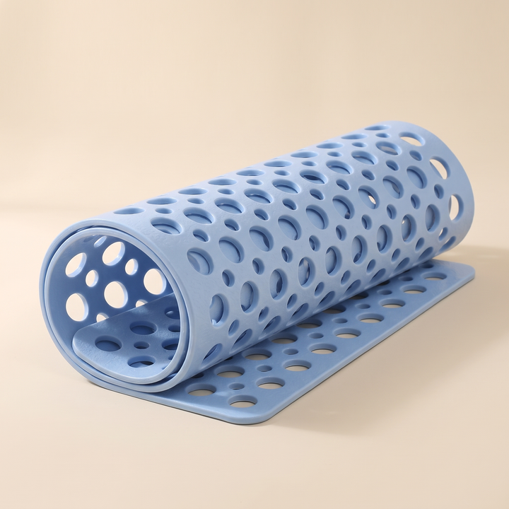 Non-Slip Shower Mat with Suction Cups in Light Blue – loosely rolled up on a plain beige background