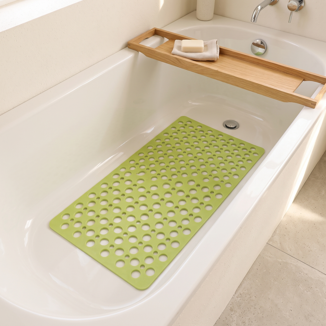 Non-Slip Shower Mat with Suction Cups in Lime Green – inside a white bathtub beneath a wooden bath caddy holding soap