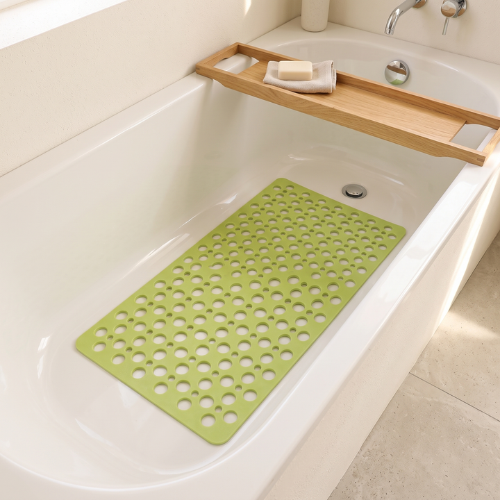 Non-Slip Shower Mat with Suction Cups in Lime Green – inside a white bathtub beneath a wooden bath caddy holding soap