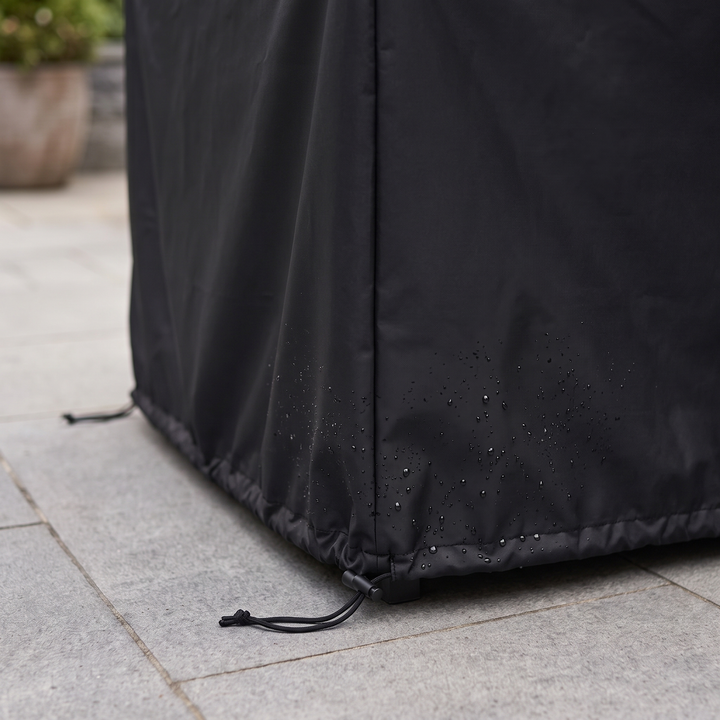 Outdoor Furniture Cover – Waterproof, Rectangular in Black – close-up of hem drawstring and water droplets on a paved patio