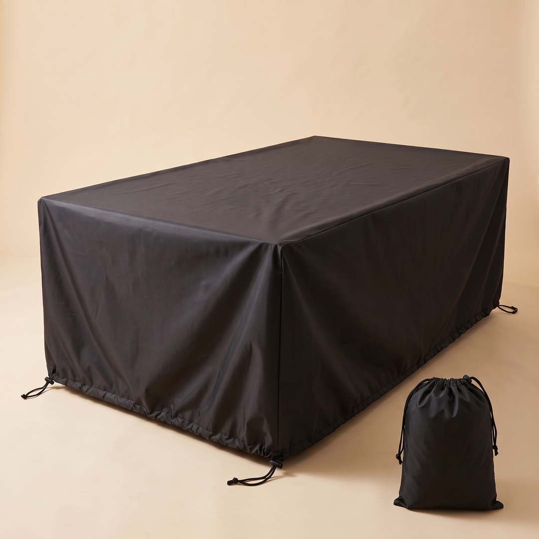 Outdoor Furniture Cover – Waterproof, Rectangular in Black – covering a rectangular table with drawstring storage pouch beside it