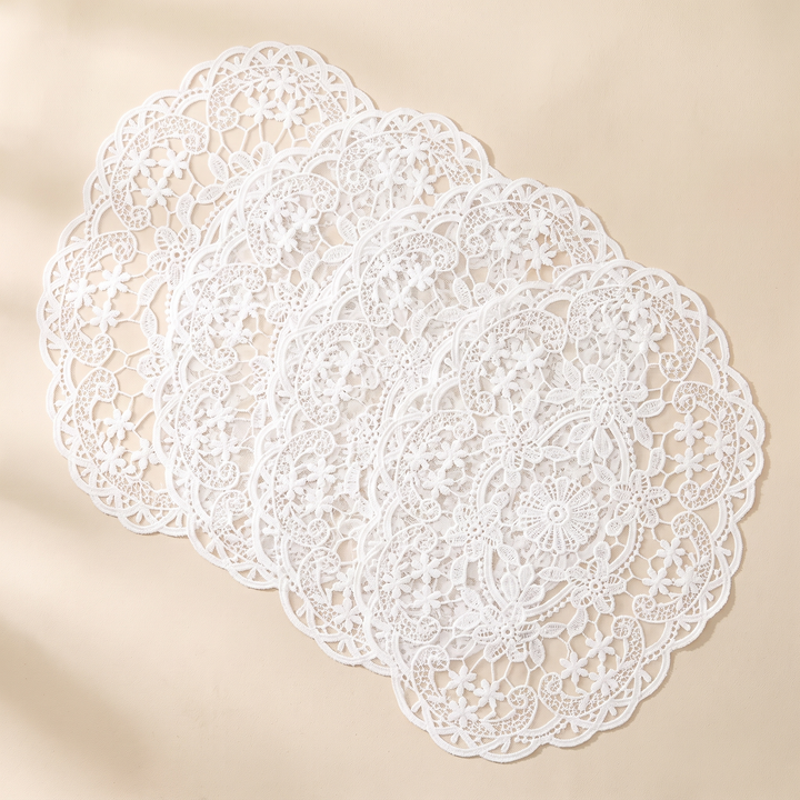 Oval Lace Placemats – Embroidered in White – four mats overlapping in a row on oat