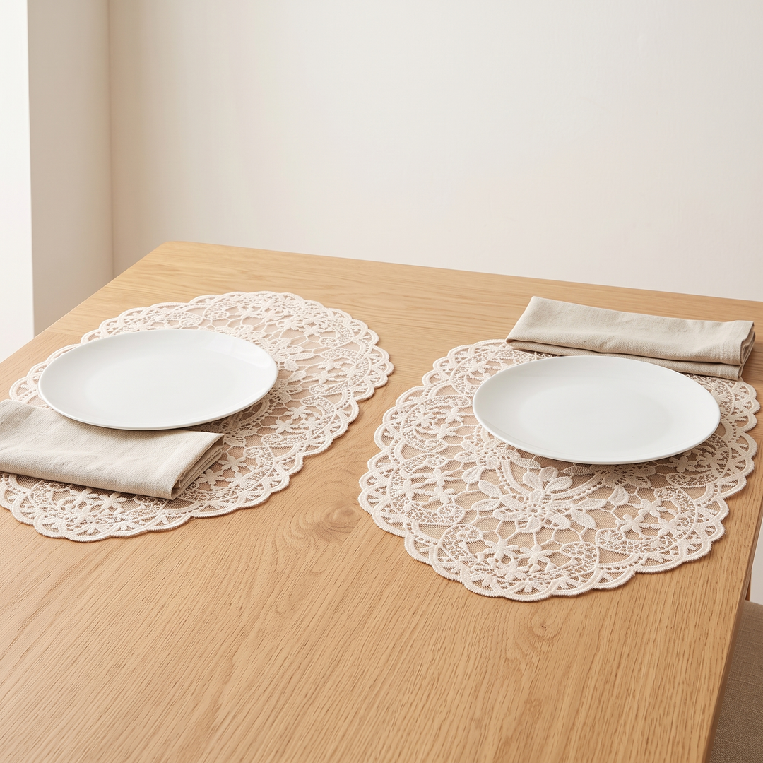 Oval Lace Placemats – Embroidered in Cream – under white plates on a light oak table