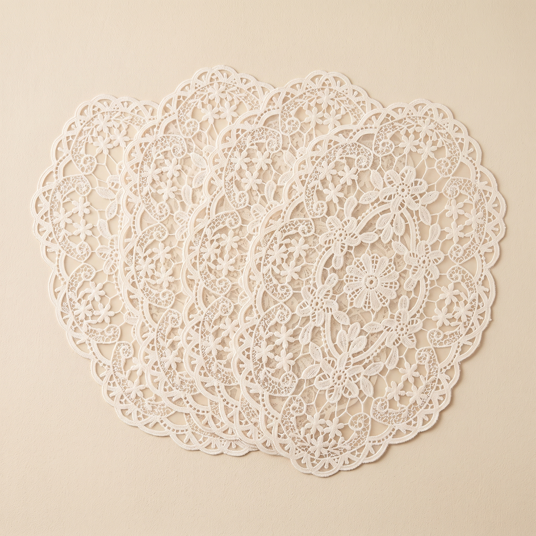 Oval Lace Placemats – Embroidered in Cream – four mats fanned on an oat backdrop
