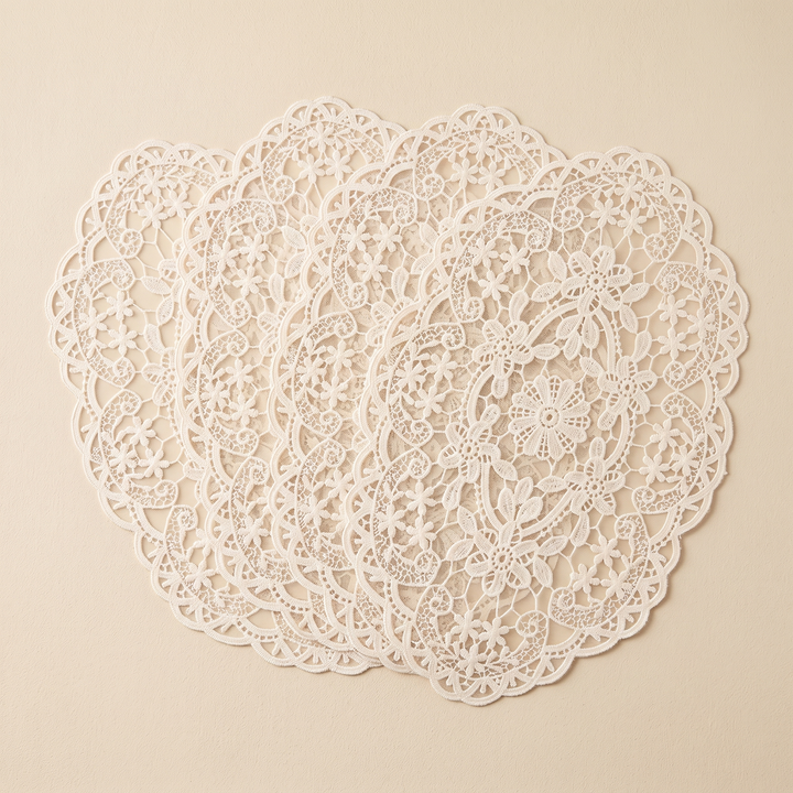 Oval Lace Placemats – Embroidered in Cream – four mats fanned on an oat backdrop