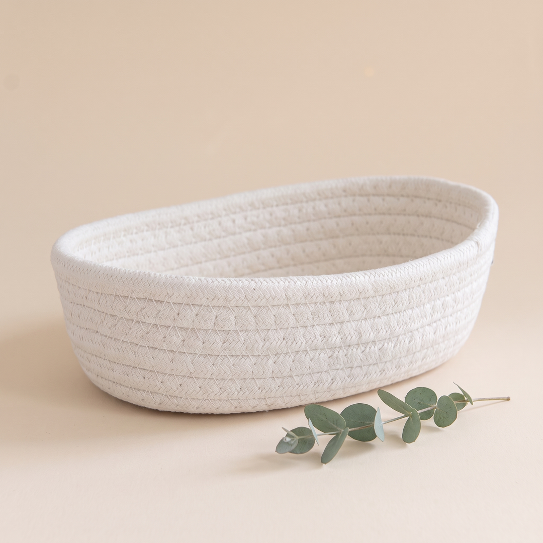 Oval Rope Basket – Cotton Rope in White – side view with a eucalyptus sprig resting in front