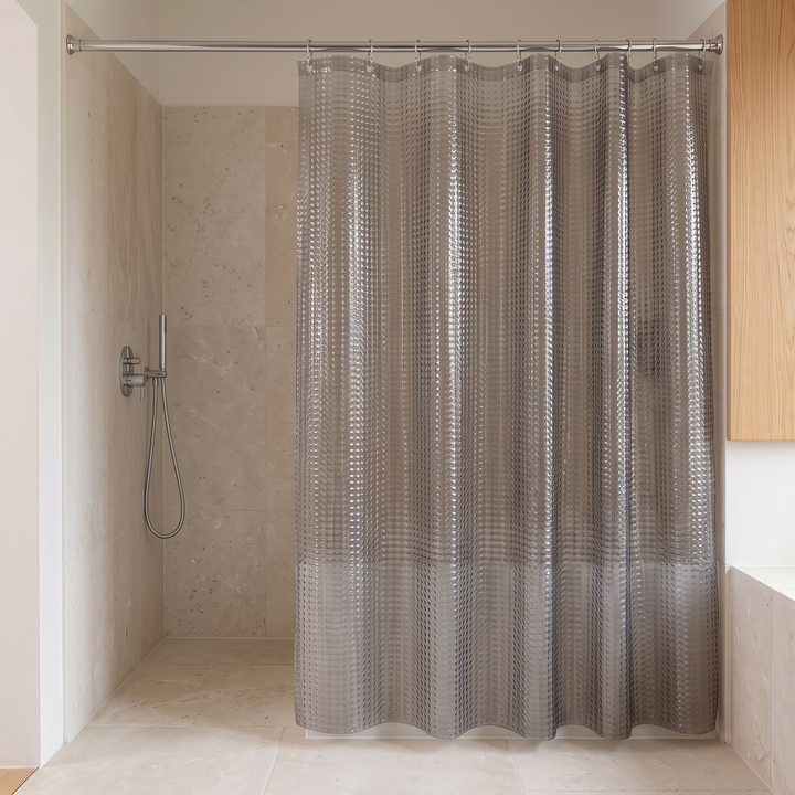 Shower Curtain Liner – Clear PEVA with Magnets in Gray Crystal – partly drawn beside a walk-in shower with handheld sprayer
