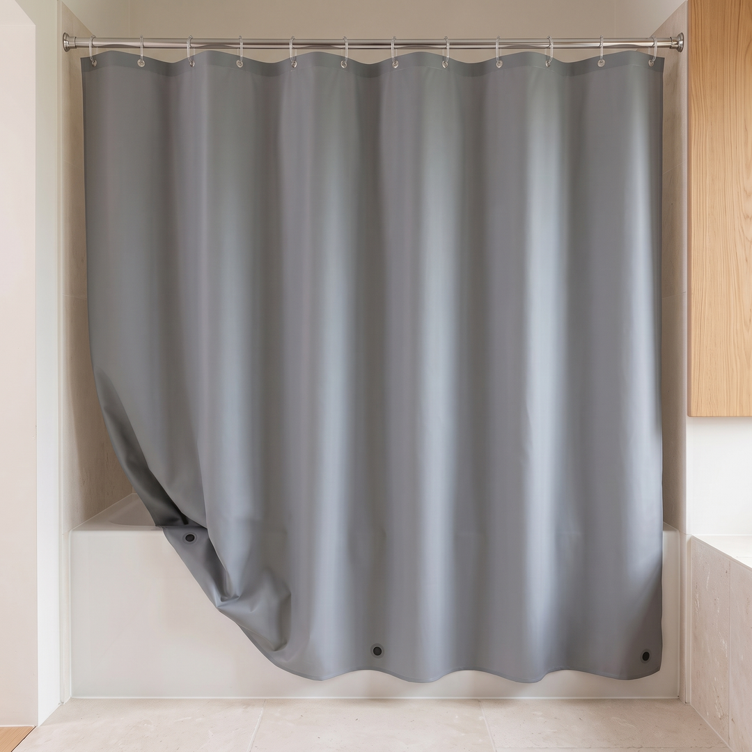 Shower Curtain Liner – Clear PEVA with Magnets in Gray – in a stone-tiled bathroom beside a wood cabinet