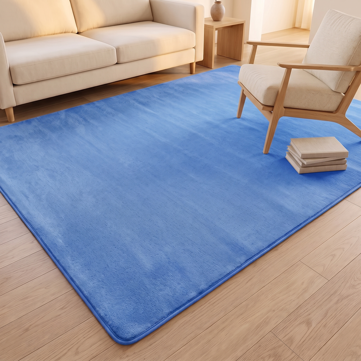 Plush Area Rug in Cornflower Blue – beside a wooden armchair with a stack of books