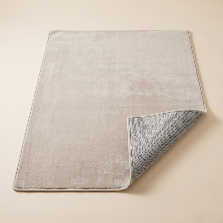 Plush Area Rug in Beige – laid flat with one corner folded over to show the non-slip dotted backing