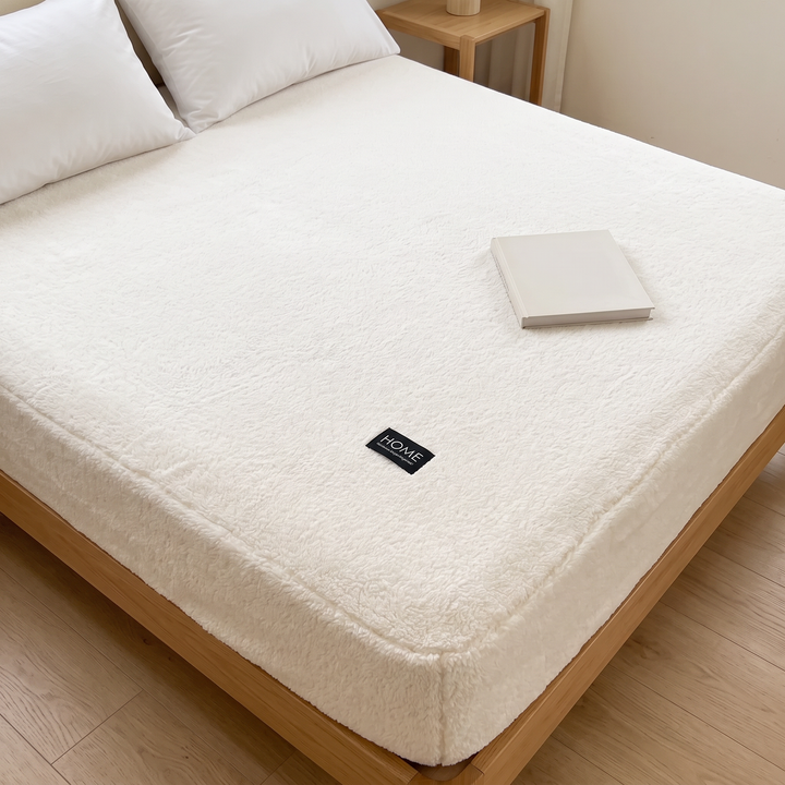 Plush Fleece Fitted Sheet – Deep Pocket in White – high angle view with a closed book on the mattress