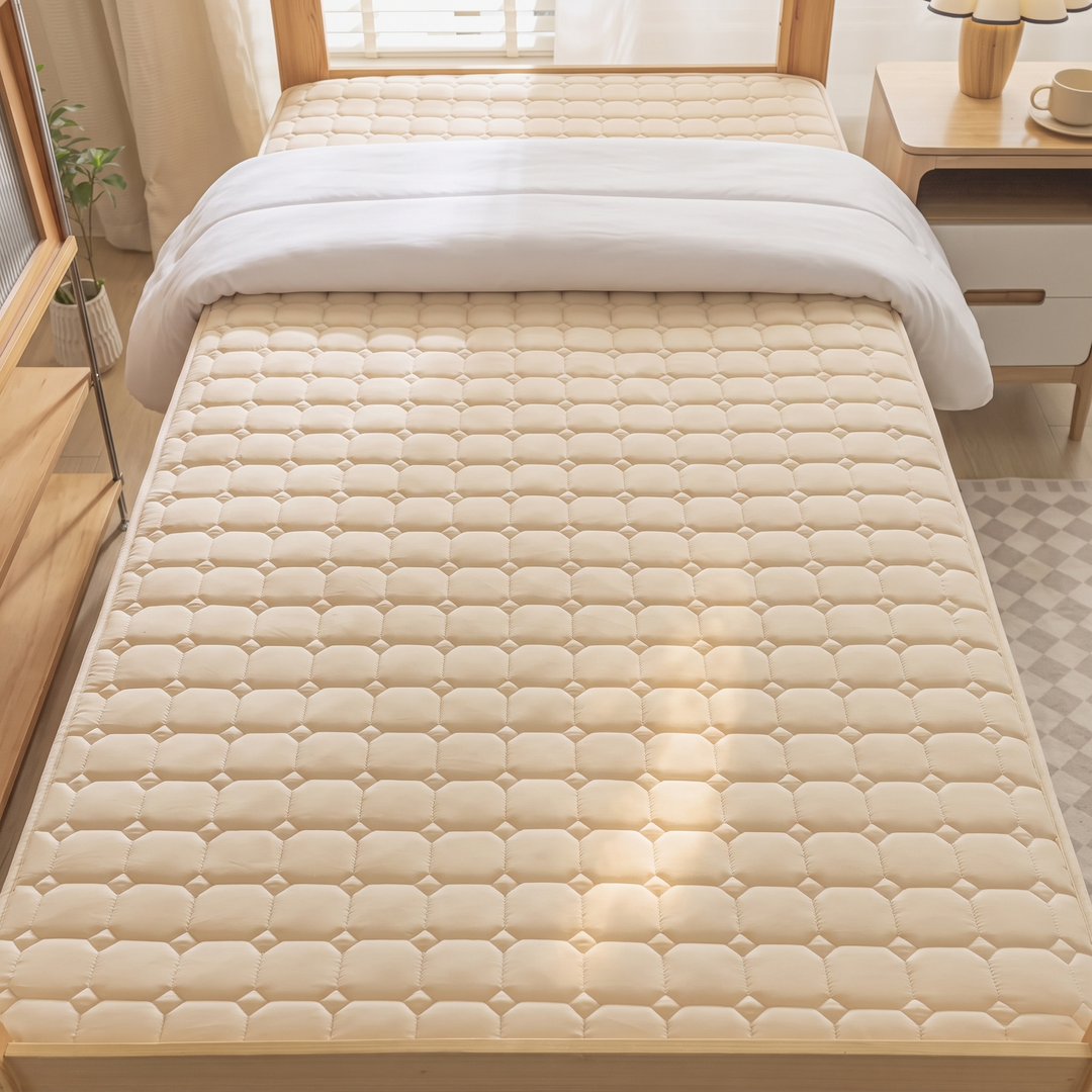 Quilted Mattress Protector – Cotton Top, Fitted in Beige – high-angle view on single bed beside nightstand and rug