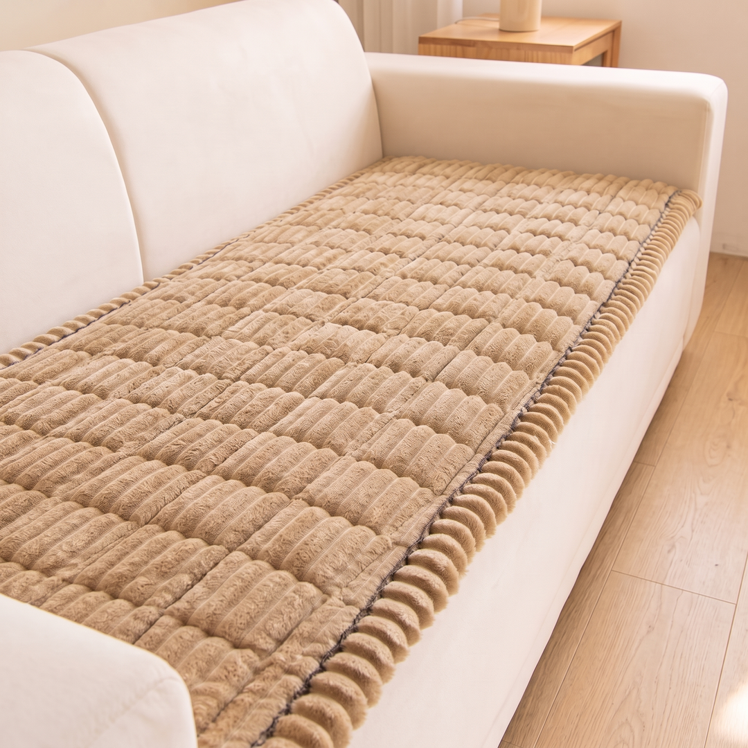 Quilted Plush Couch Cover – Ribbed in Beige – laid across a cream sofa seat in a bright room