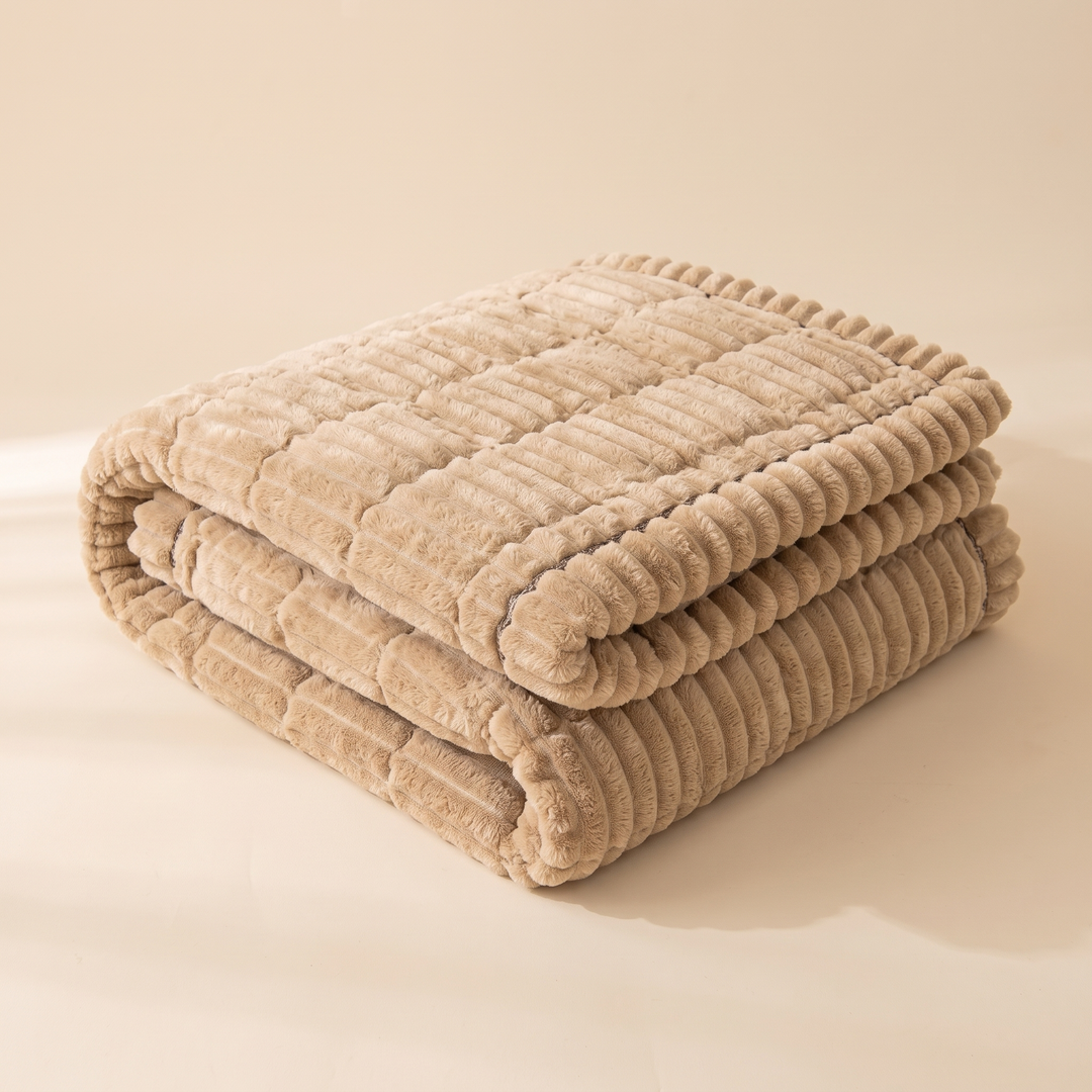 Quilted Plush Couch Cover – Ribbed in Beige – folded in a neat stack on a plain studio surface