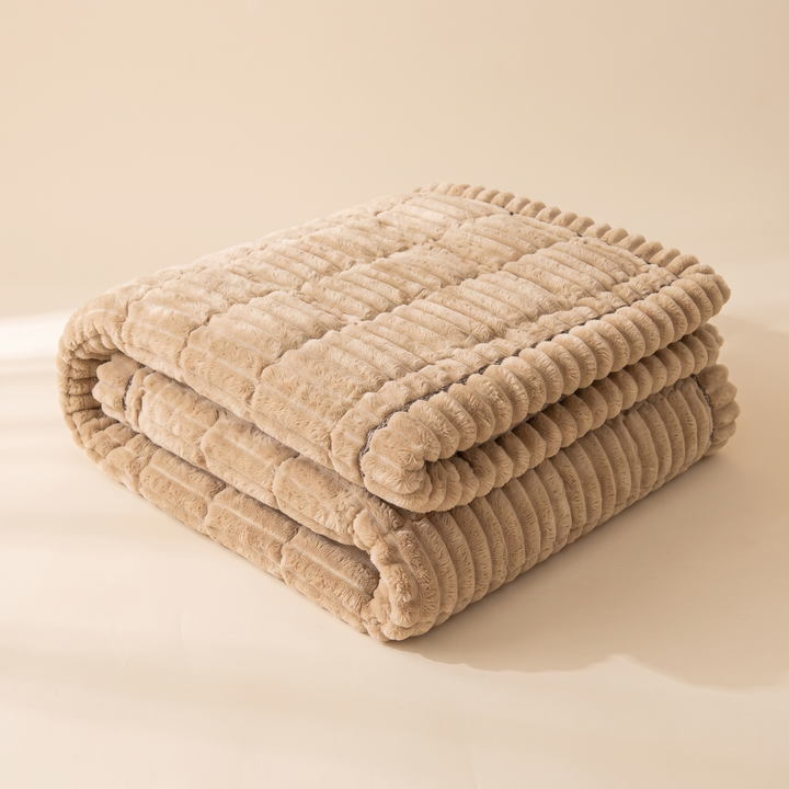 Quilted Plush Couch Cover – Ribbed in Beige – folded in a neat stack on a plain studio surface