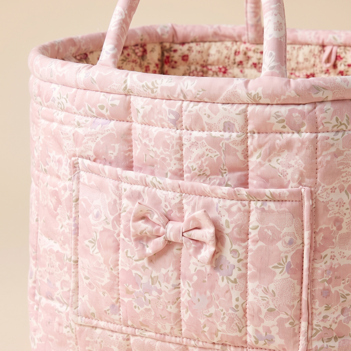 Quilted Fabric Storage Basket with Handles in Pink – Ditsy Floral – close-up of the front pocket with bow and quilted stitching