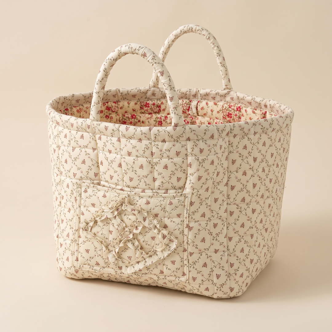 Quilted Fabric Storage Basket with Handles in Cream – Ditsy Floral – angled corner view showing two side panels and inner lining