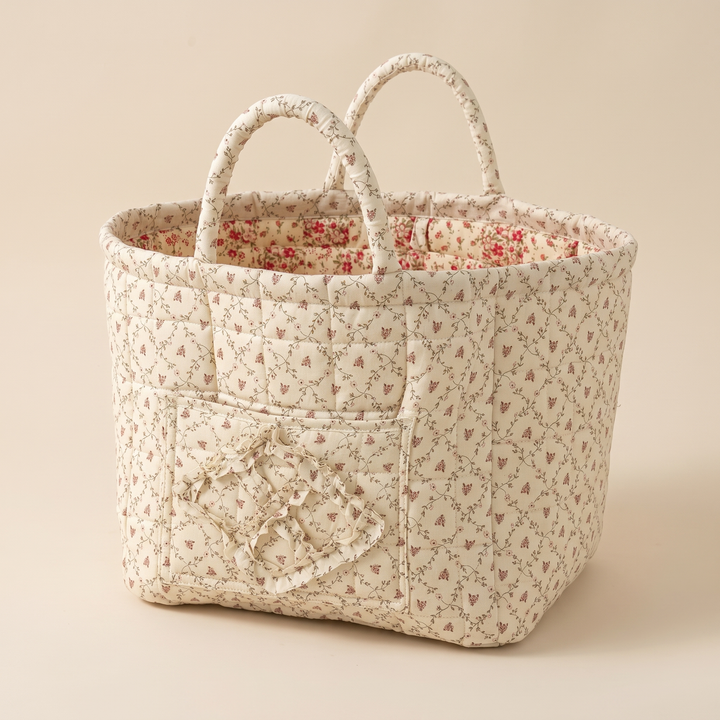Quilted Fabric Storage Basket with Handles in Cream – Ditsy Floral – angled corner view showing two side panels and inner lining