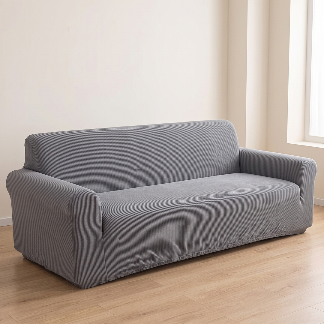 Ribbed Stretch Couch Cover in Gray – fitted on a three-seat sofa in a bright room