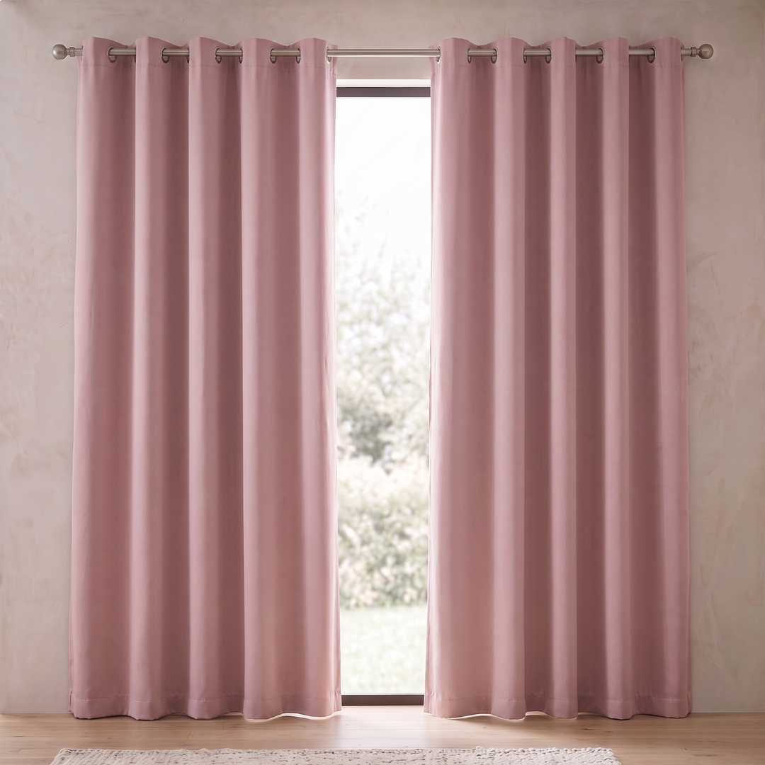 Room Darkening Curtain Panel – Grommet Top in Pink – center gap revealing sunlit lawn and leafy shrubs outside