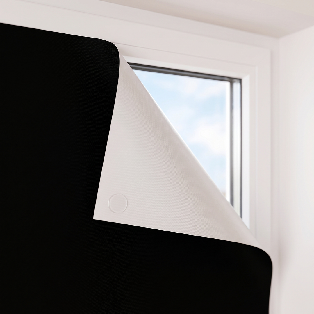 Room-Darkening Window Cover – Cut to Size in Black – close-up of the small round tab on the reverse side