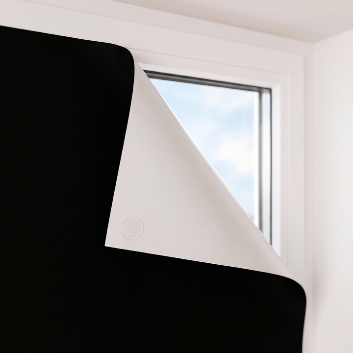 Room-Darkening Window Cover – Cut to Size in Black – close-up of the small round tab on the reverse side