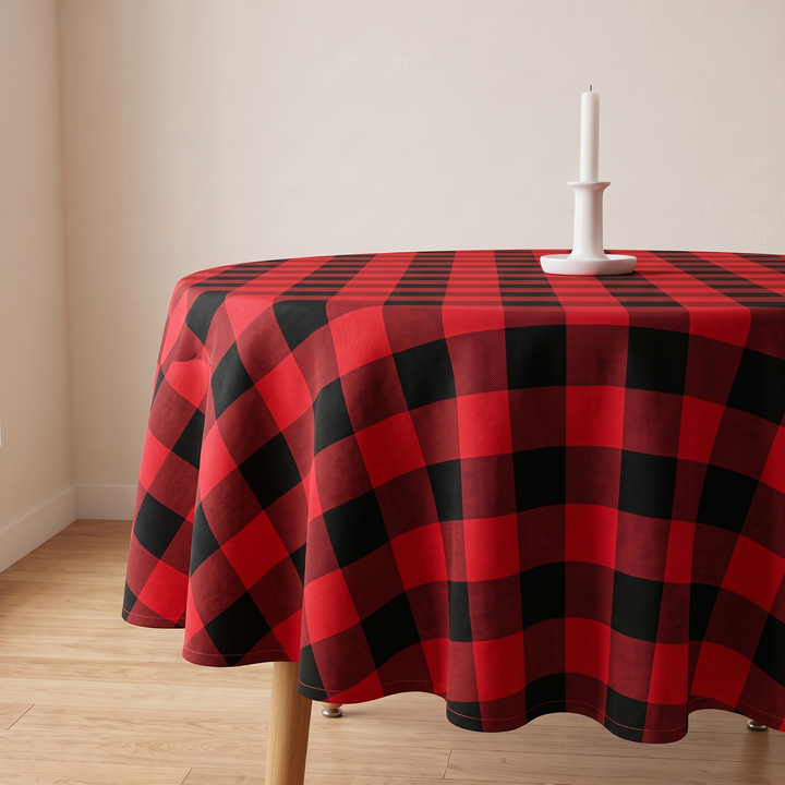 Round Christmas Tablecloth – Plaid in Red Buffalo Check – on a round table with a white candlestick, beside a plain wall