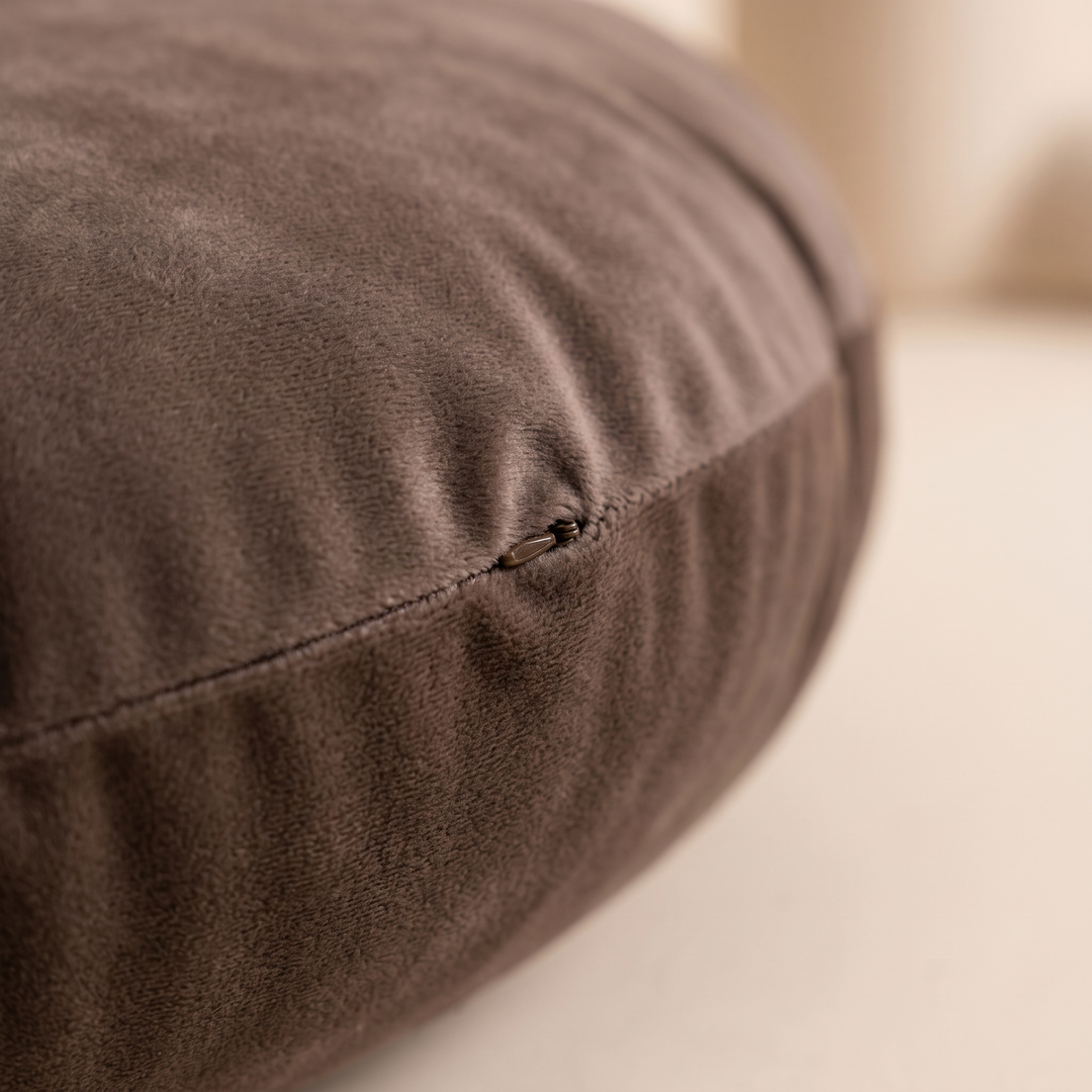 Round Velvet Pillow Cover in Chocolate Brown – close-up of the side seam and hidden zipper on a cream surface