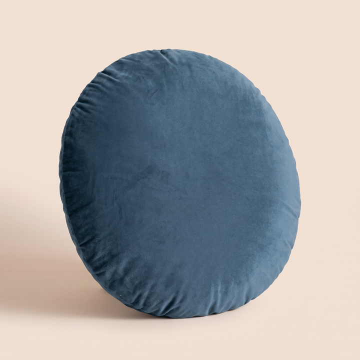 Round Velvet Pillow Cover in Slate Blue – turned at a slight angle showing the plump edge depth