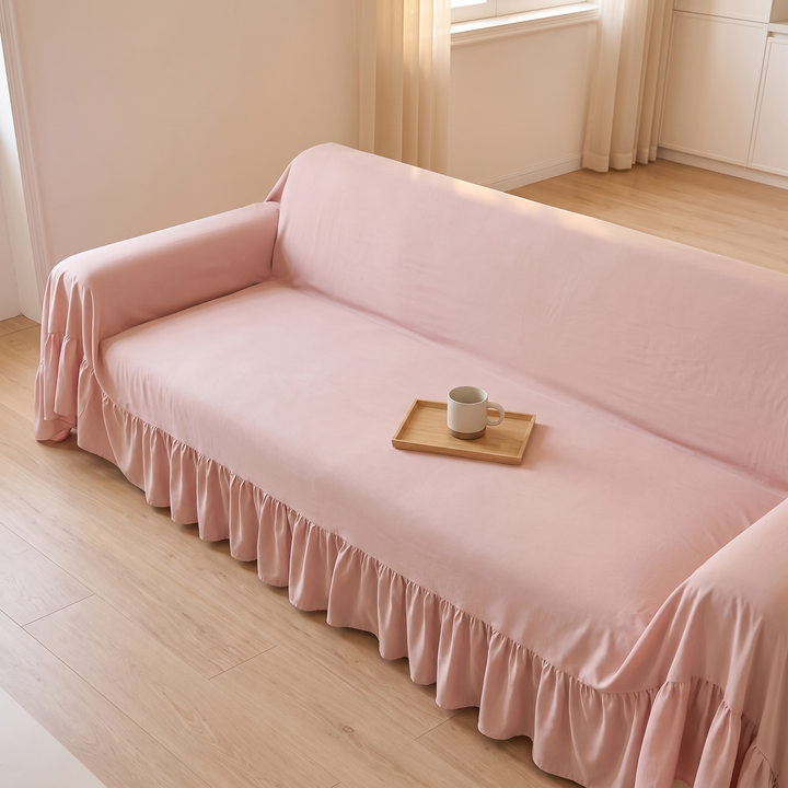 Ruffled Couch Cover in Light Pink – high angle with a mug and wooden tray on the seat