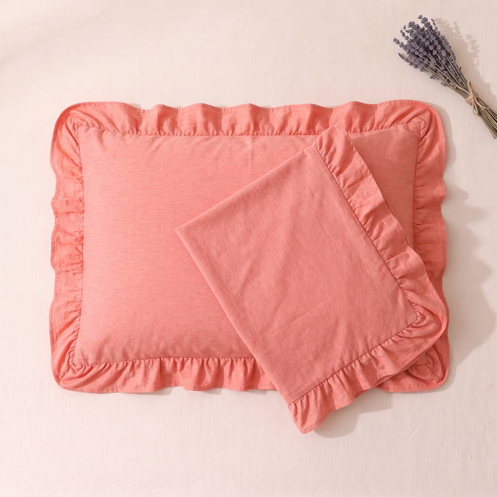 Cotton Pillowcases – Ruffled Plaid, Set of 2 in Coral – overlapping pair with twine-tied lavender bunch at top right