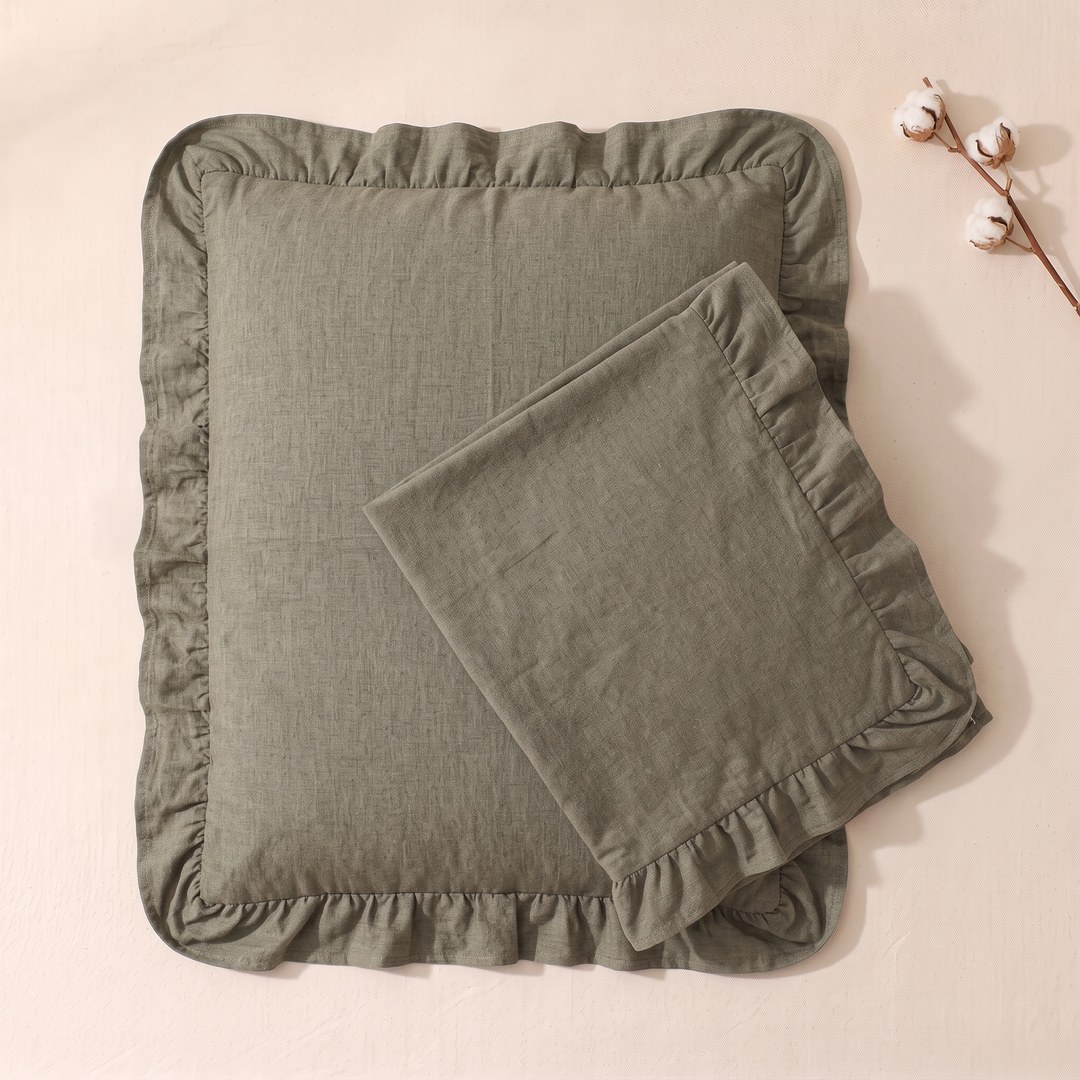 Cotton Pillowcases – Ruffled Plaid, Set of 2 in Khaki – one folded case atop another beside a cotton branch