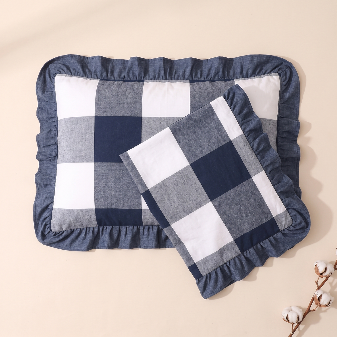 Cotton Pillowcases – Ruffled Plaid, Set of 2 in Navy Buffalo Check – overlapping pair on cream backdrop, cotton boll stem lower right