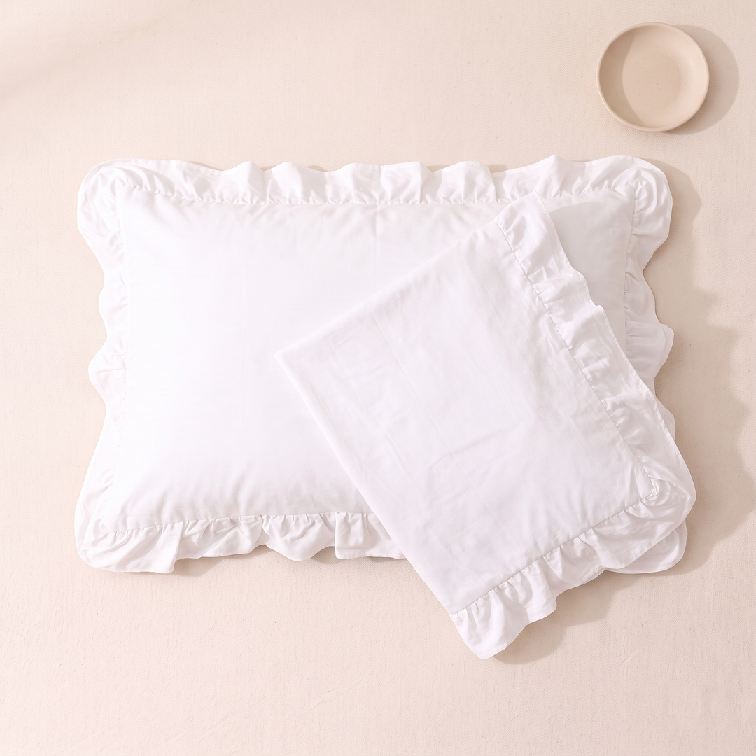 Cotton Pillowcases – Ruffled Plaid, Set of 2 in White – one case folded over another, empty dish at top right