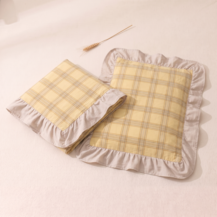 Cotton Pillowcases – Ruffled Plaid, Set of 2 in Yellow Plaid – folded case beside flat case with a wheat stalk above