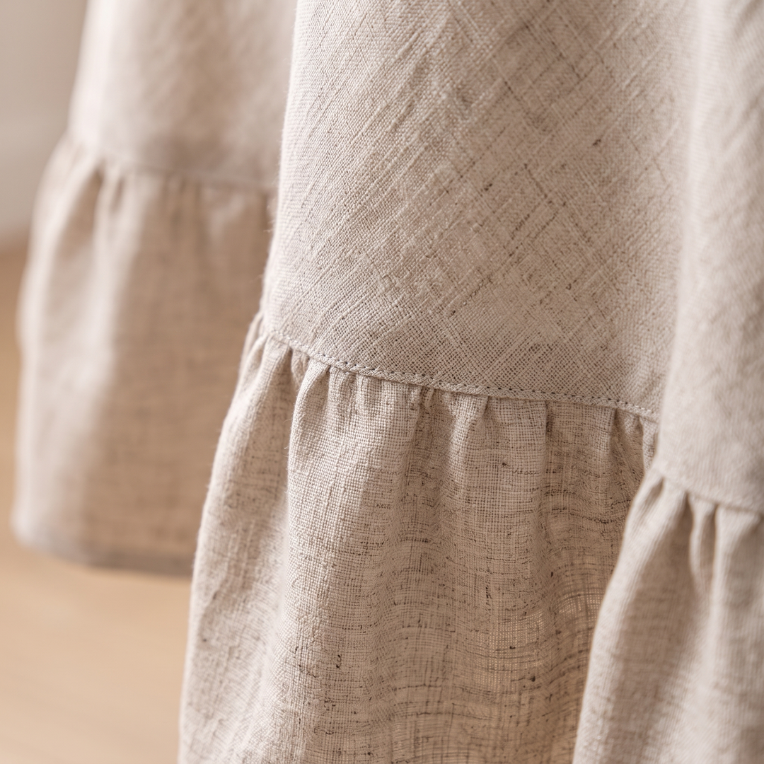 Ruffled Round Tablecloth in Beige – close-up of the gathered ruffle hem and stitched seam