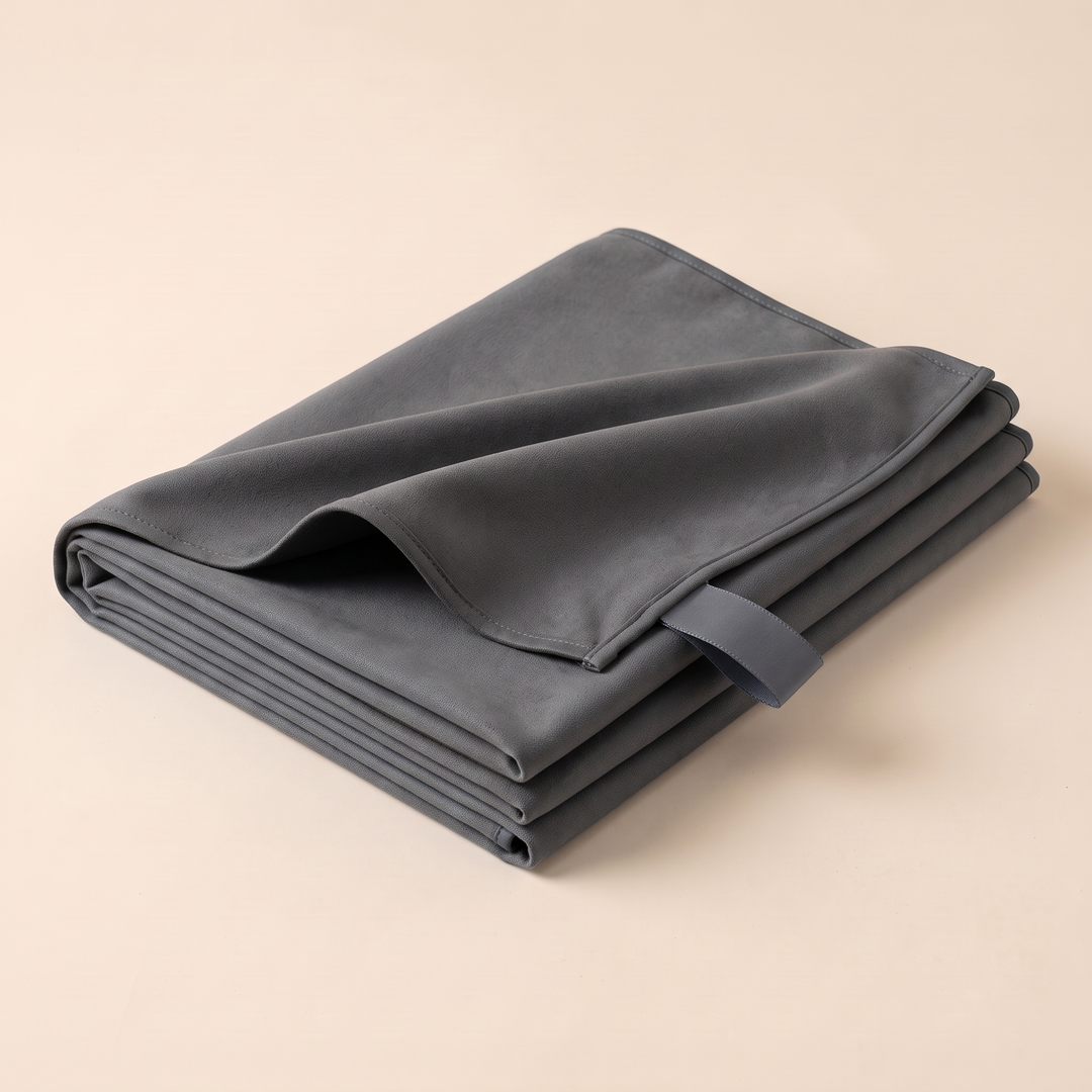 Sand-Free Beach Towel – Quick-Dry in Dark Gray – angled view of the folded stack showing the small hanging loop