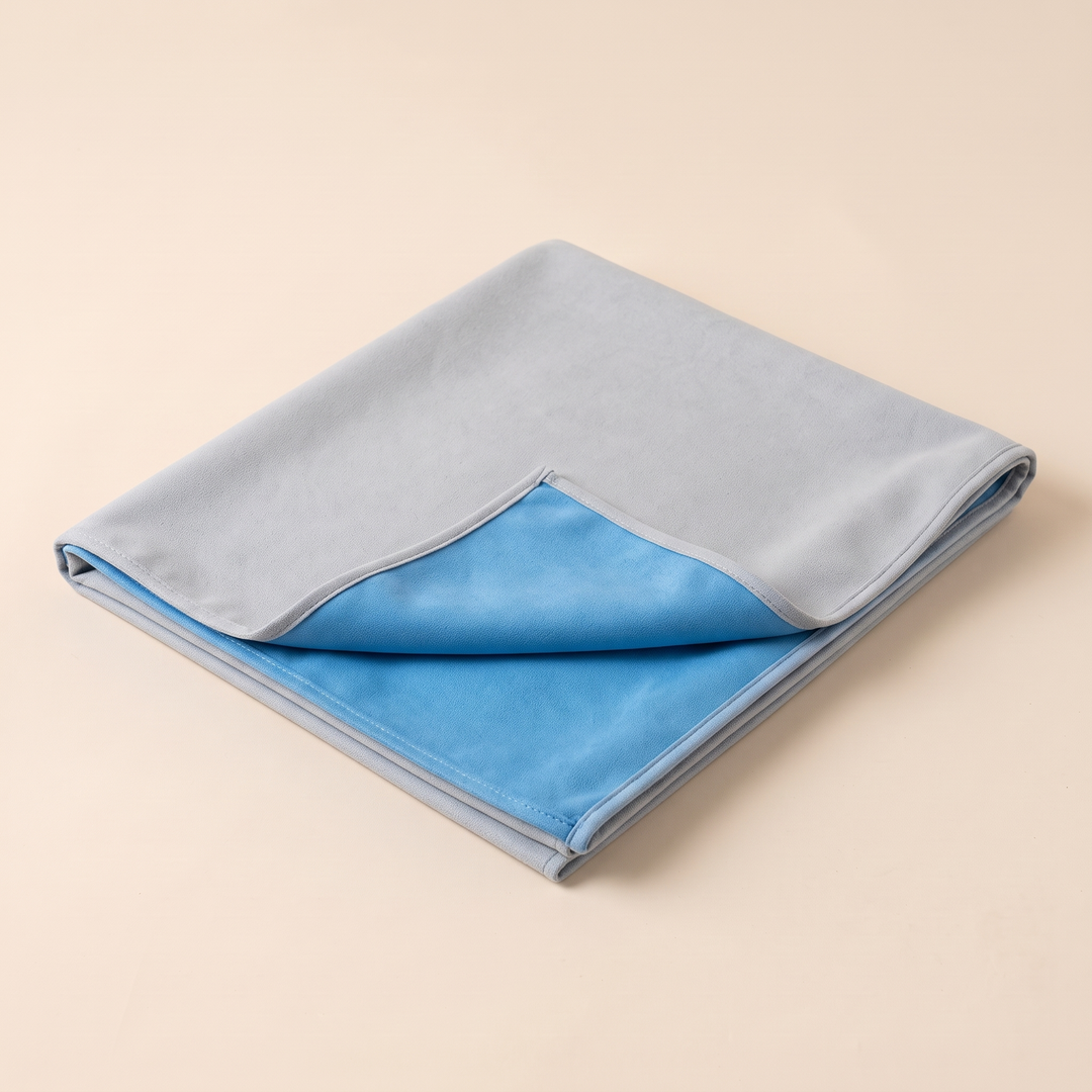 Sand-Free Beach Towel – Quick-Dry in Gray &amp; Blue – low three-quarter angle showing bound edges and diagonal fold