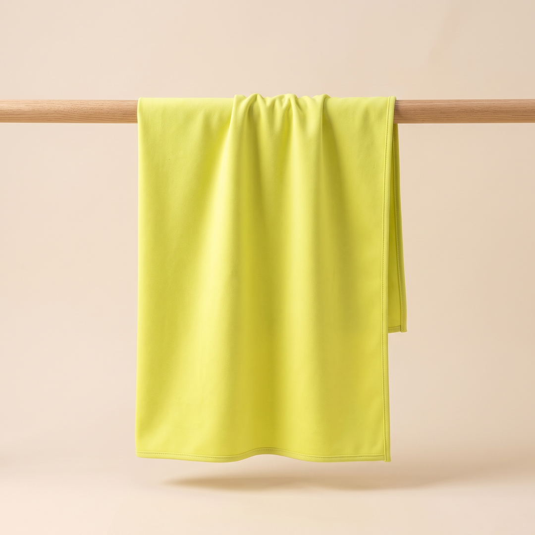 Sand-Free Beach Towel – Quick-Dry in Lime Yellow – hung unfolded over a slim wooden pole, front view