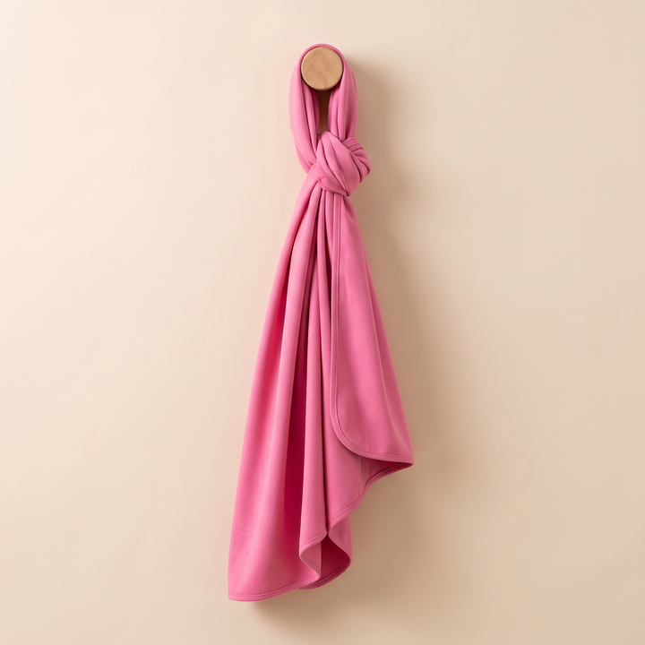 Sand-Free Beach Towel – Quick-Dry in Rose Pink – knotted around a round wooden wall peg and hanging down