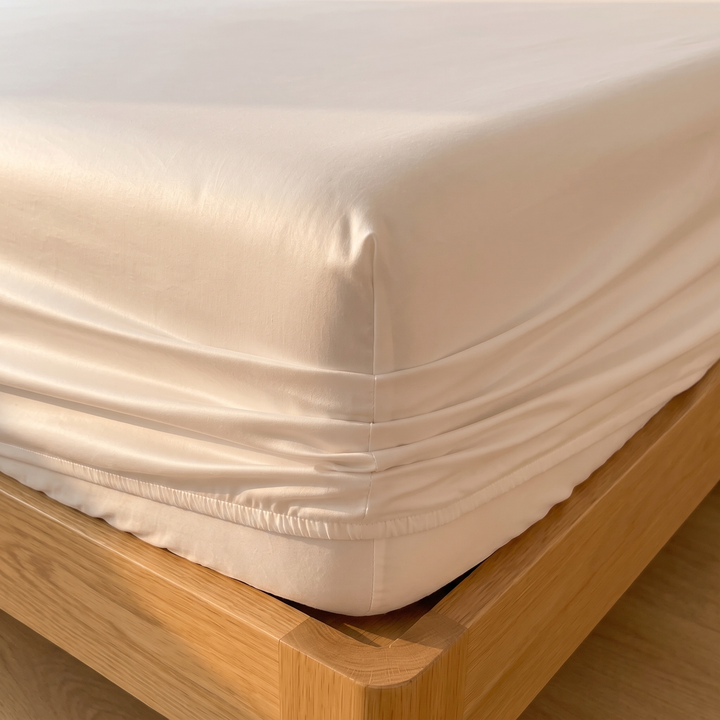 Sateen Fitted Sheet Set with 2 Pillowcases in White – close-up of a snug corner on an oak bed frame