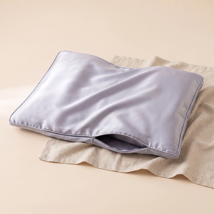 Satin Pillowcase for Contour Pillows in Lilac – resting on a crumpled linen cloth, three-quarter view