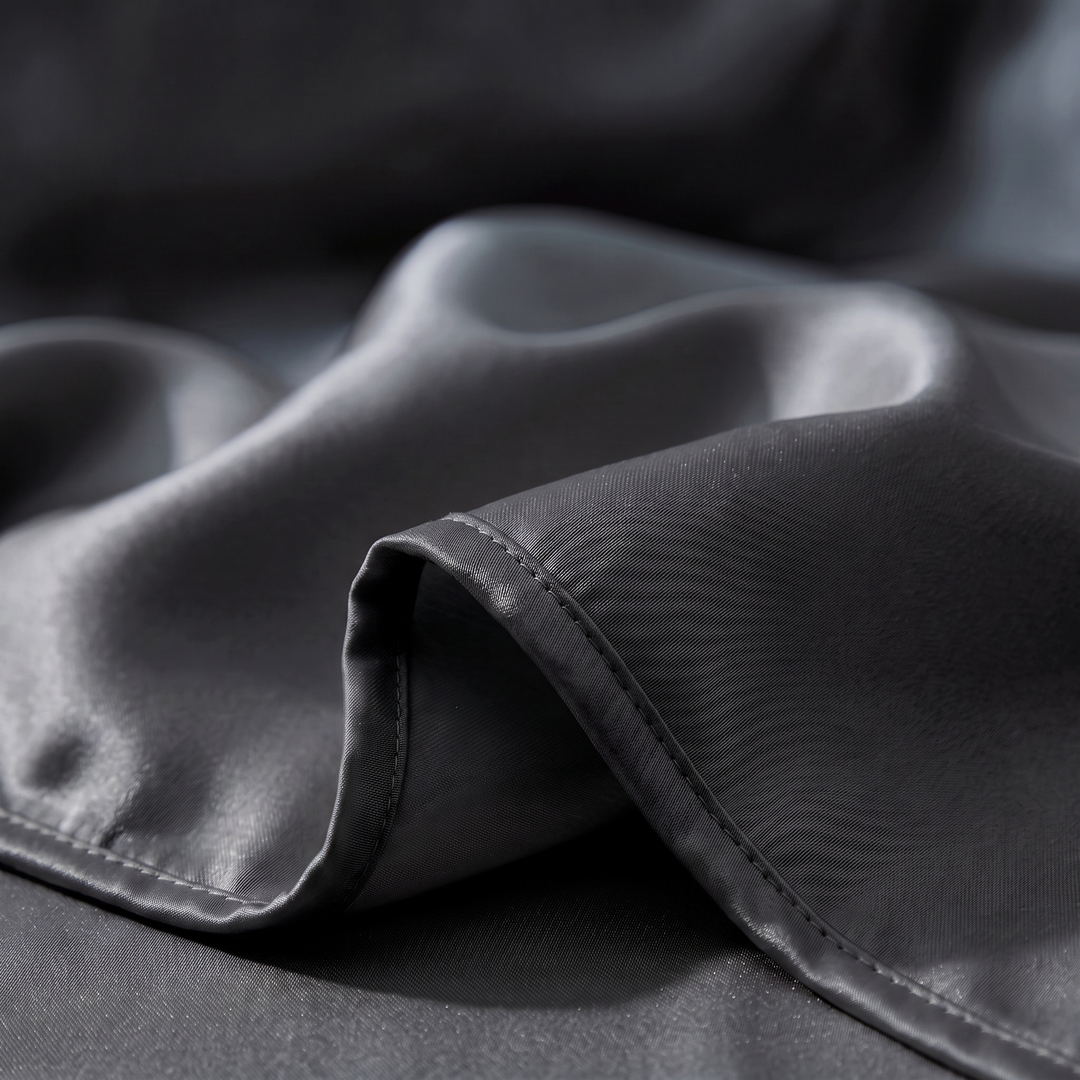 Close-up of the smooth black satin and stitched hem