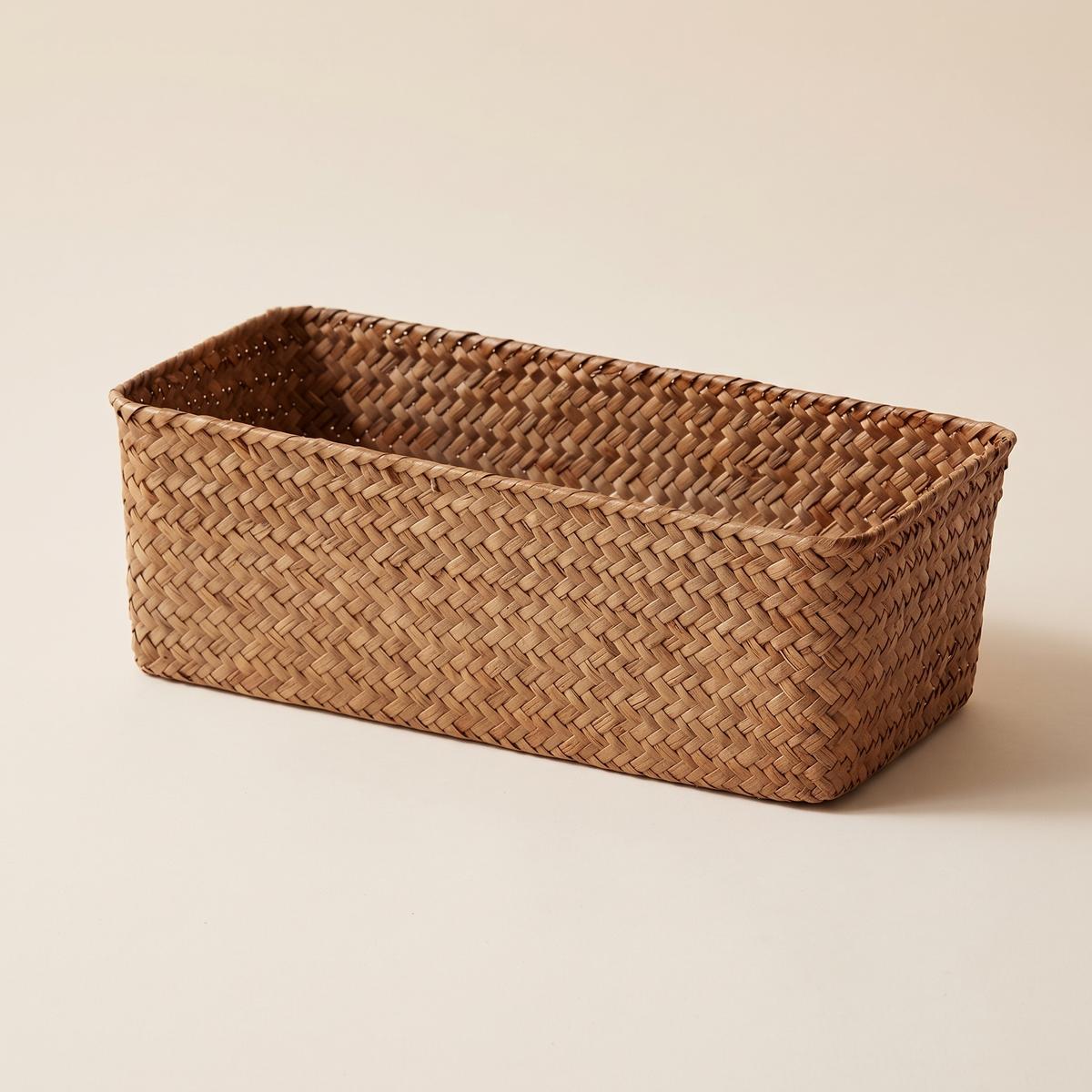 Seagrass Woven Basket – Bathroom Storage in Natural – empty rectangular basket at a three-quarter angle on a plain cream background